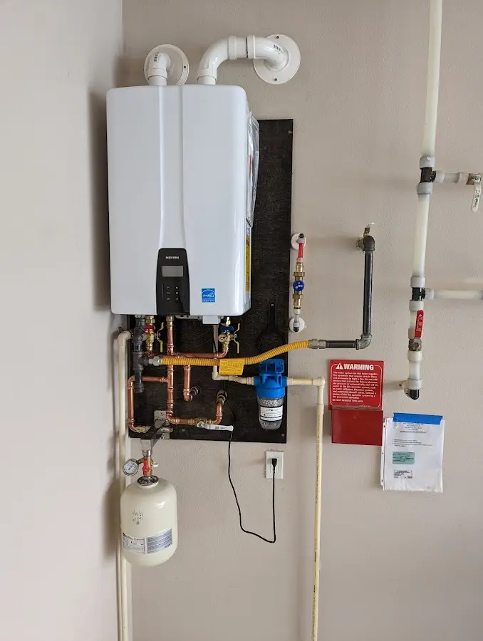 Professional plumber installing copper piping in a Dumas home